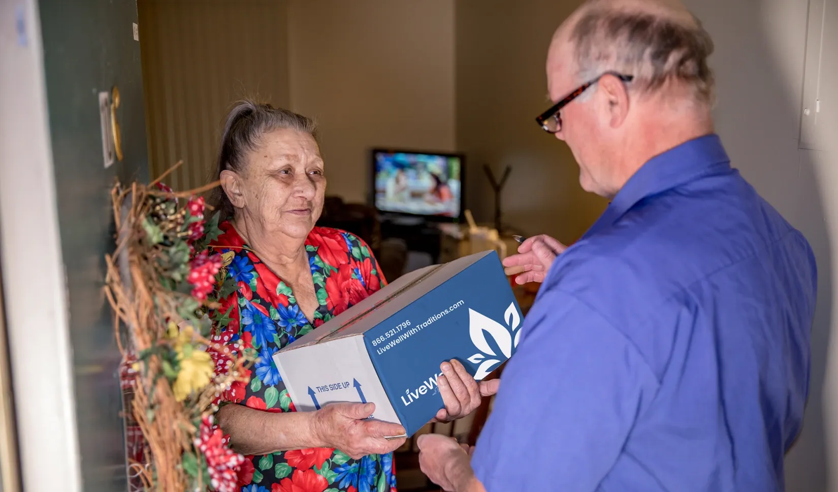 elderly woman receiving live well package