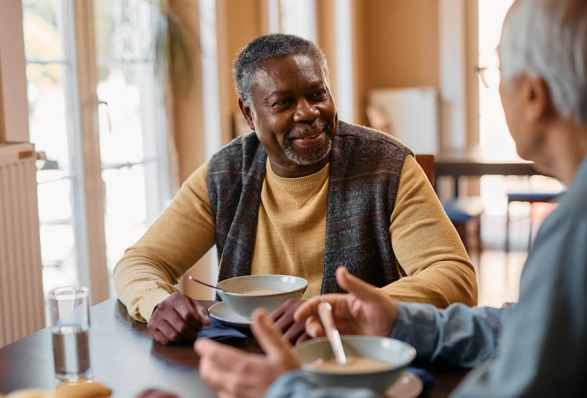 Two older gentlemen having a meal and conversation