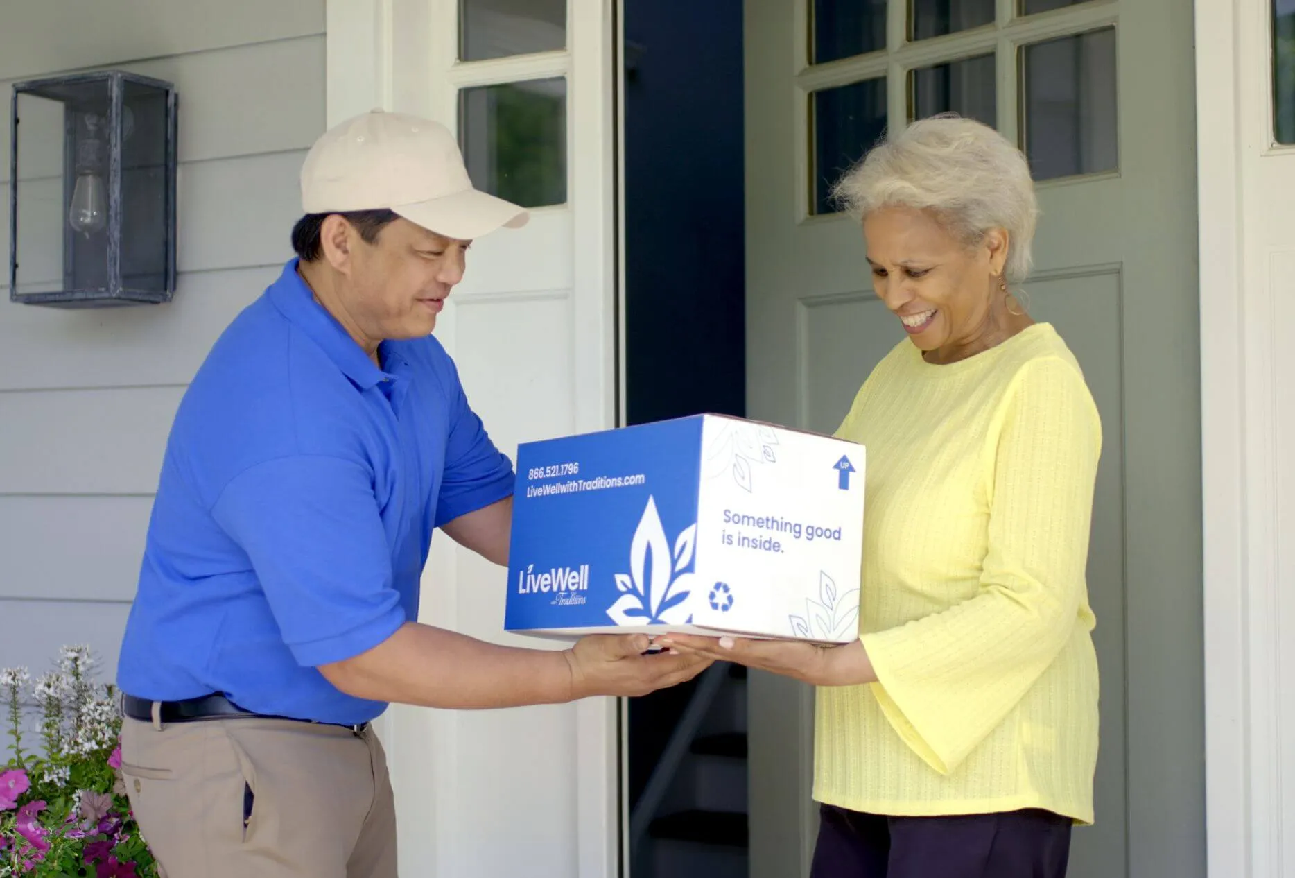 Customer receiving LiveWell with Traditions delivery box from driver