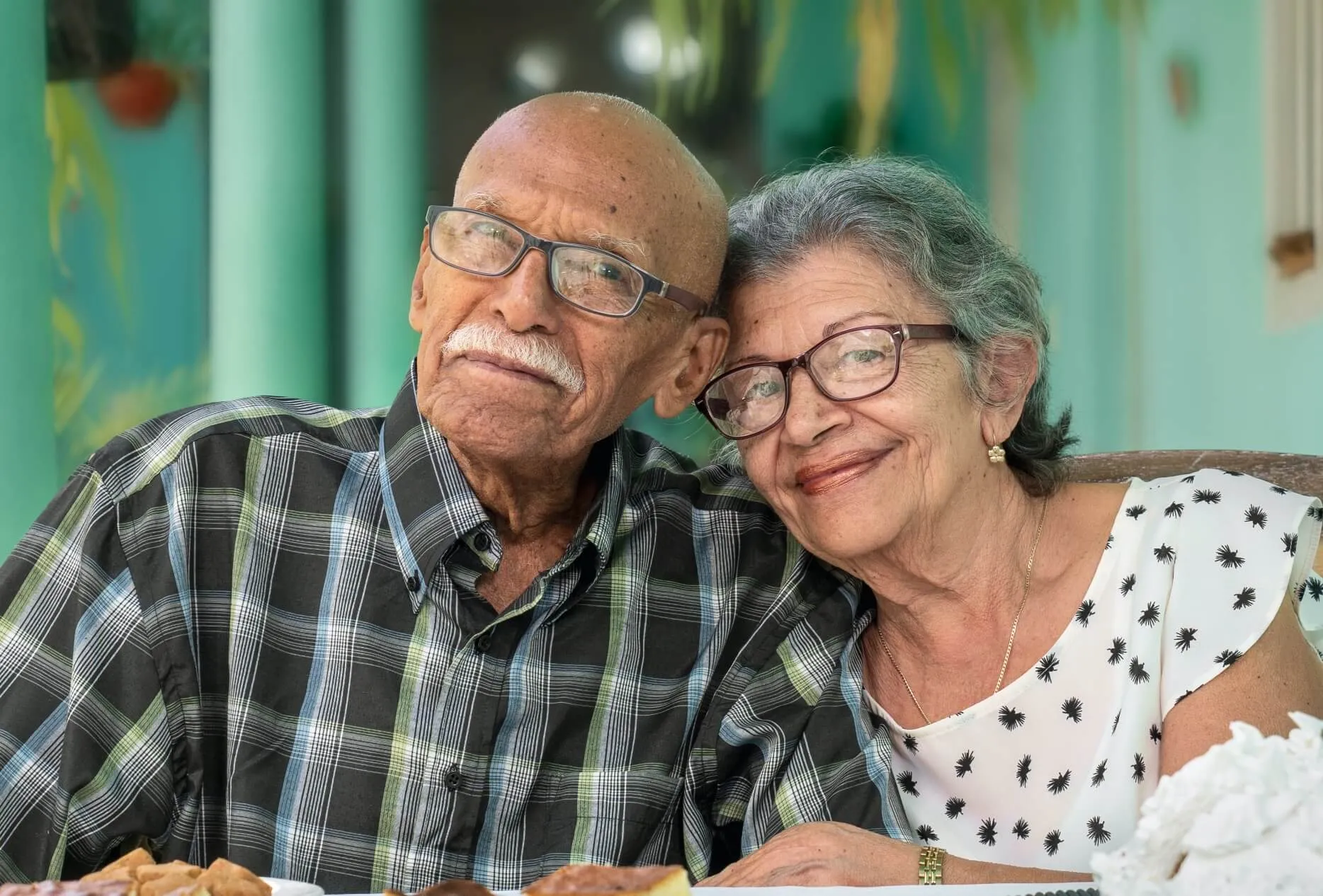 An elderly couple smiling at the camera