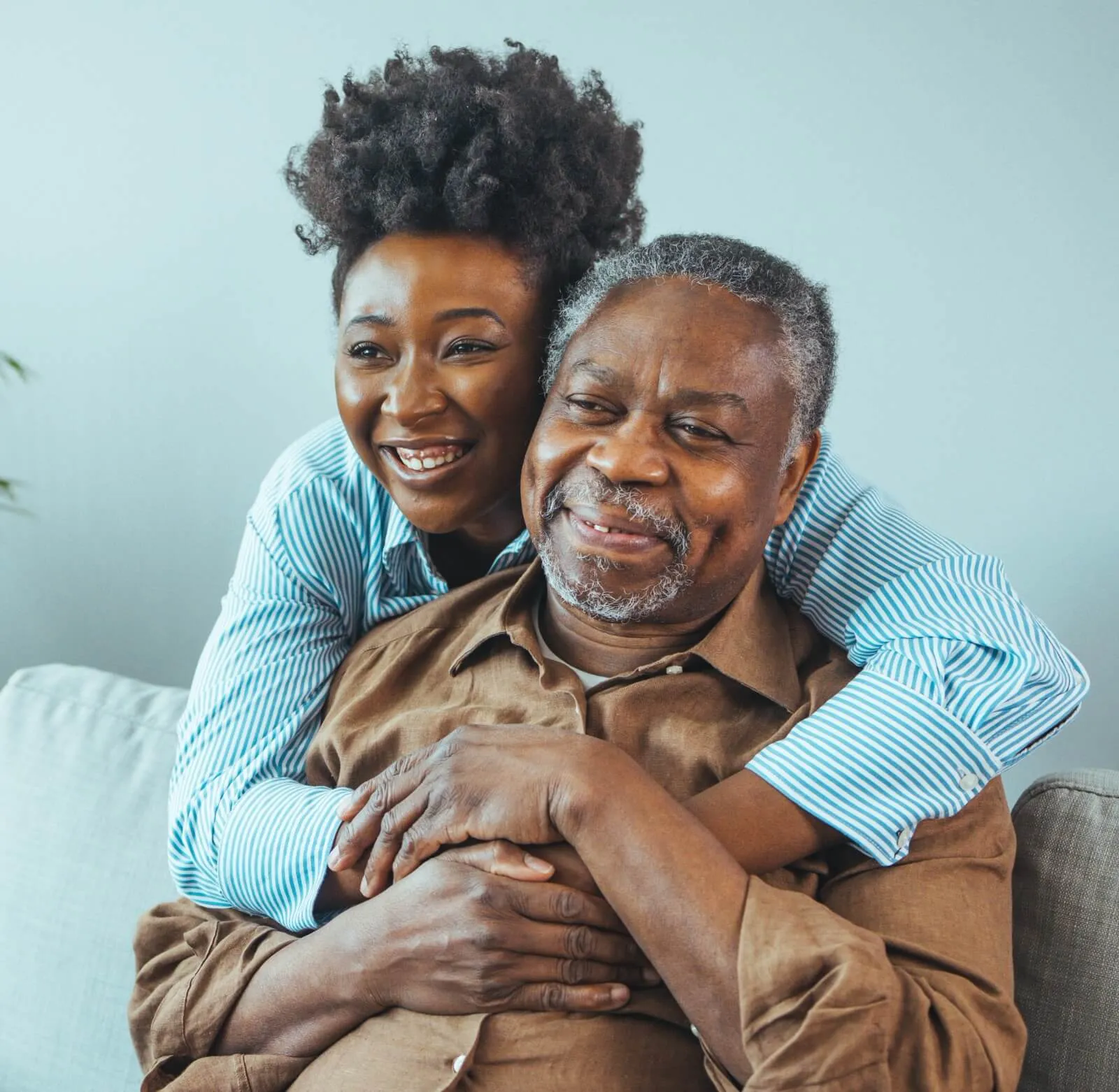 woman hugging elderly man