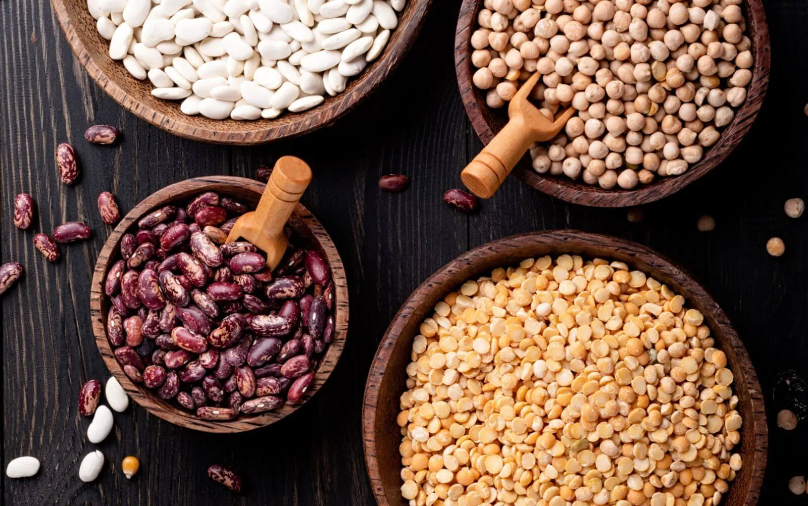 Assorted legumes in wooden bowls