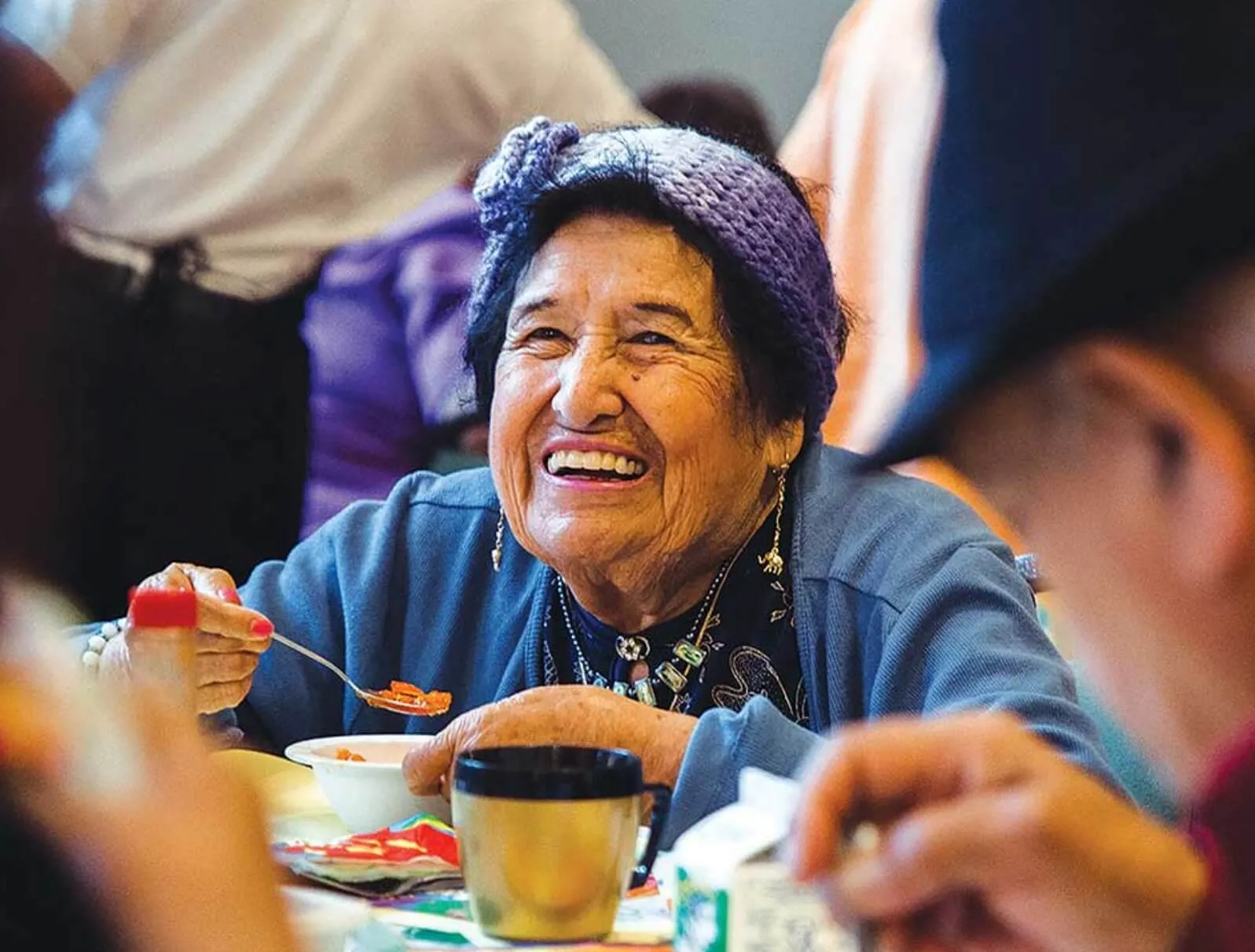 elderly woman eating and smiling