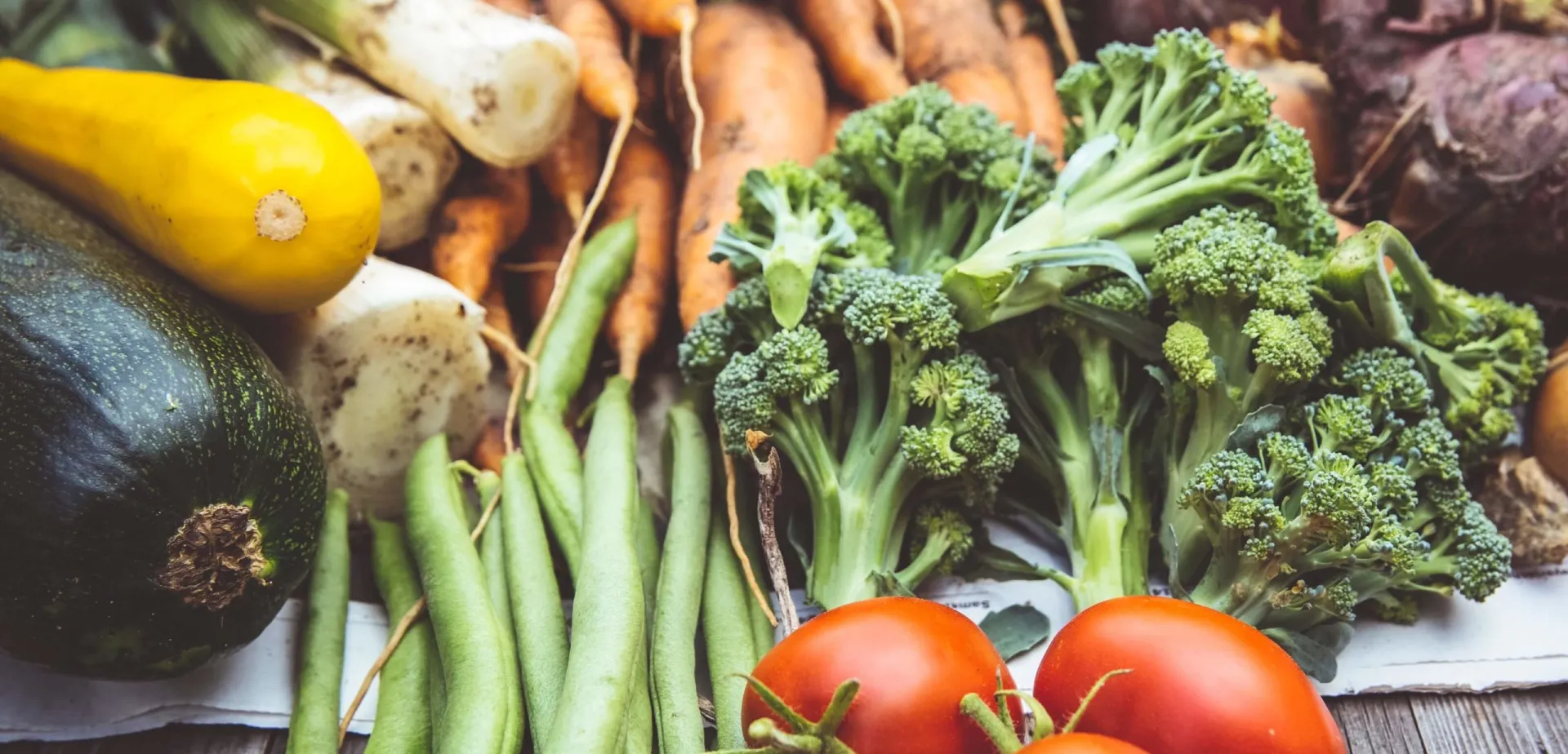 An assortment of vegetables on a wooden table