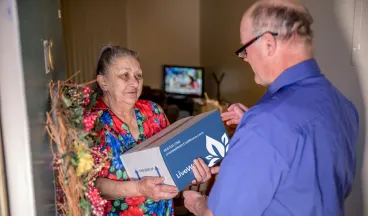 elderly woman receiving live well package