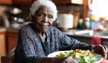 elderly woman eating a healthy meal