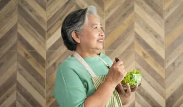 elderly woman eating a salad