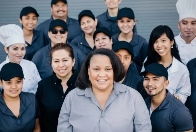Employees in a group smiling