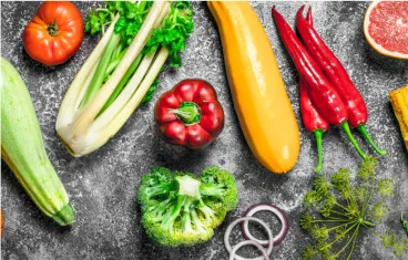 Overhead of various vegetables on slate counter