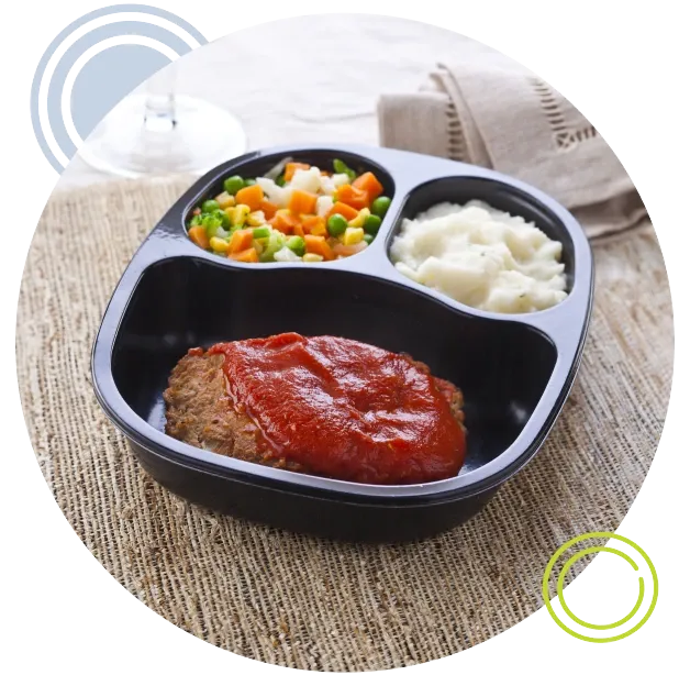 Meatloaf, mixed vegetables and mashed potatoes in reheatable container