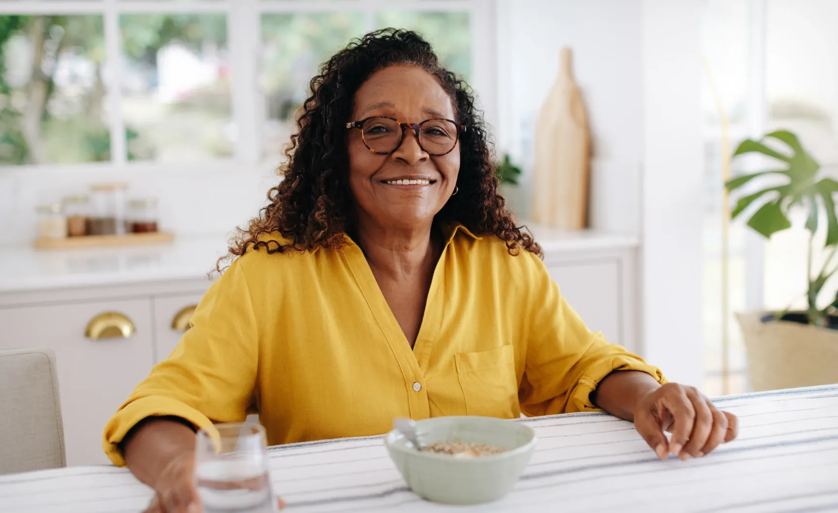 a woman holding a glass of water