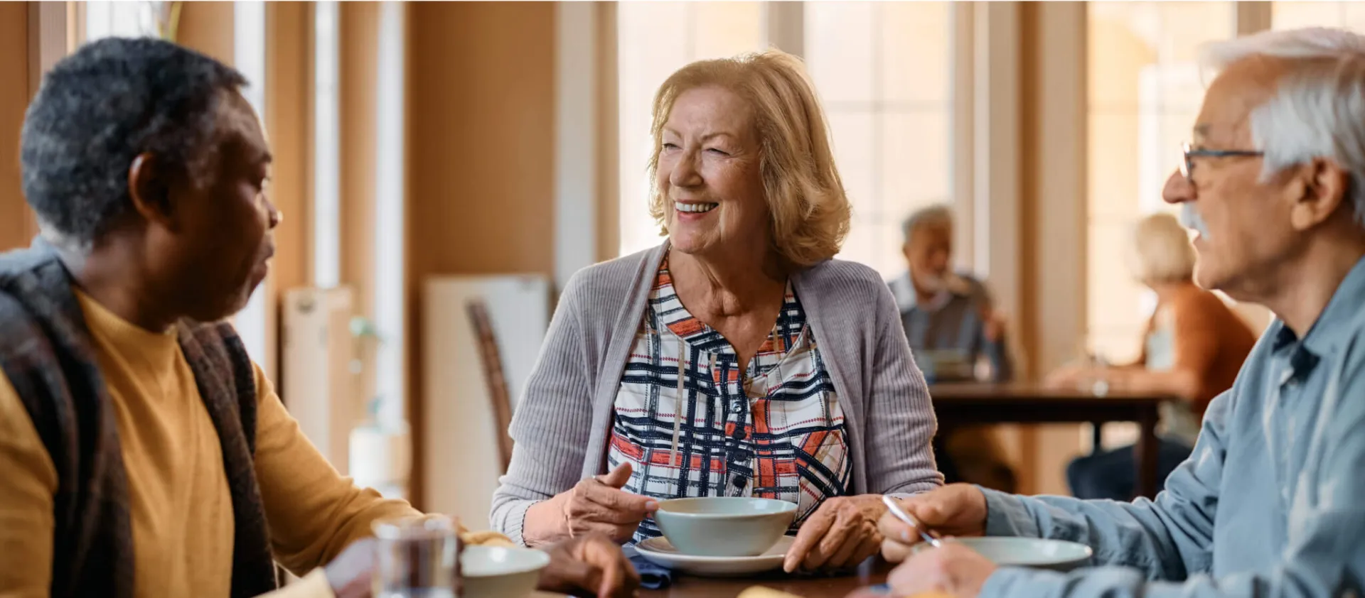 three seniors eating and chatting