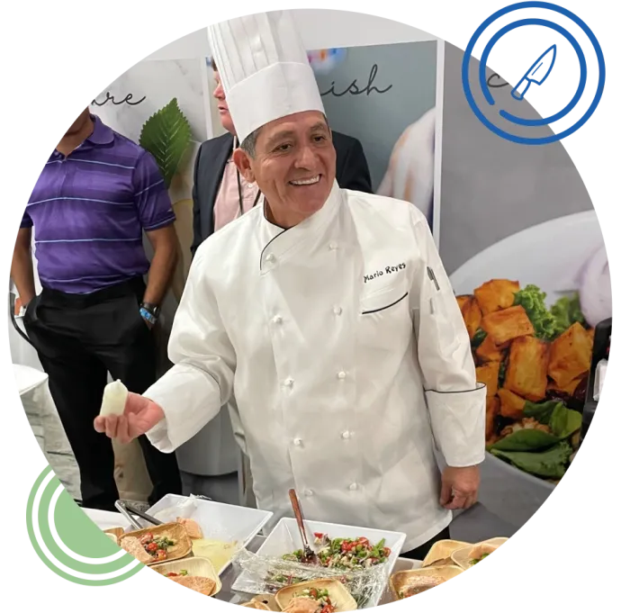 Chef Mario smiling while at a food display