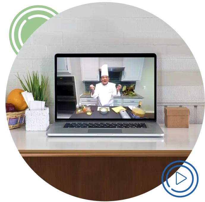 Laptop on table with chef demonstration being streamed