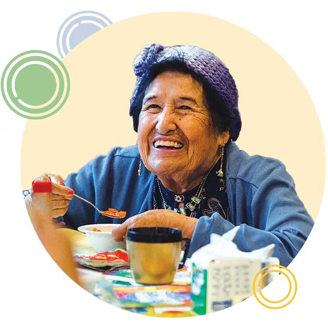 A senior woman eating and smiling