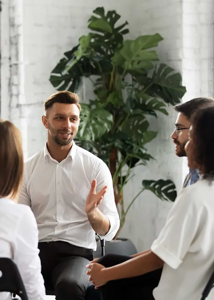 Group of people sitting in a circle speaking