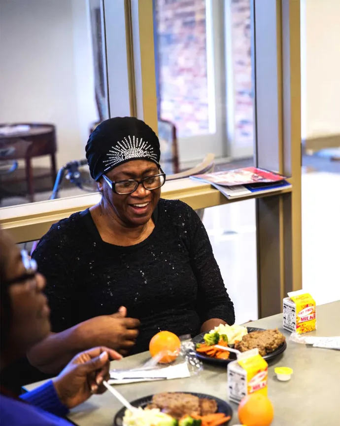 Woman having a meal at communal table